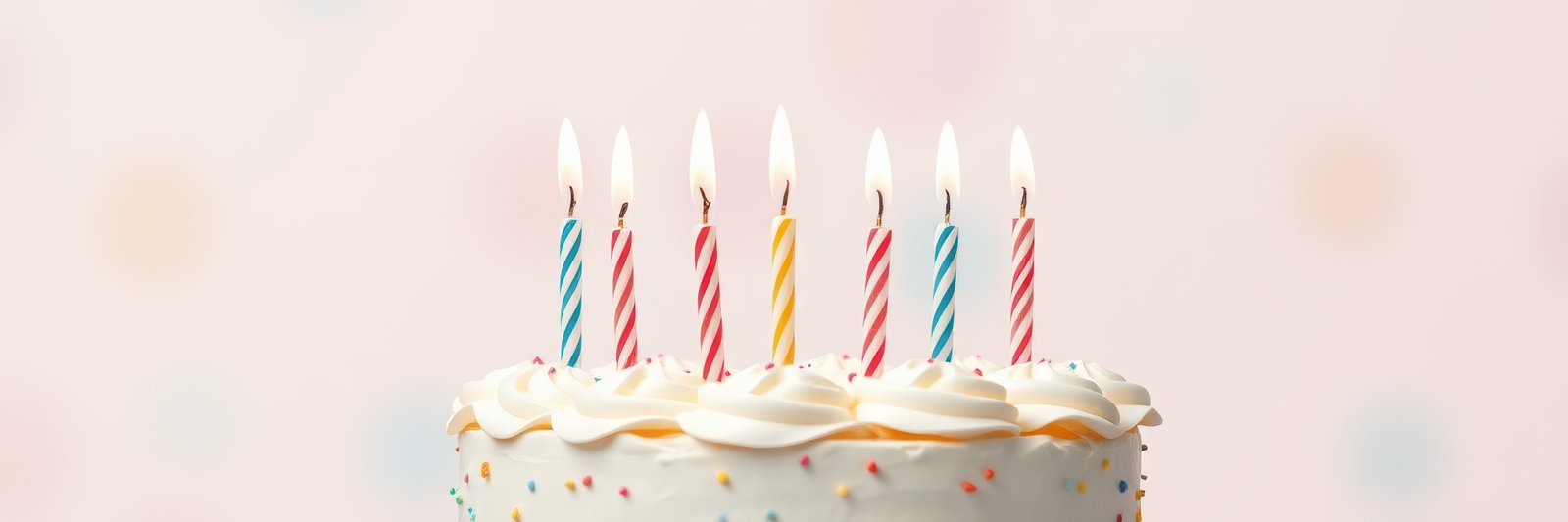 Colorful birthday cake with lit candles and festive decorations in a cheerful setting for a celebration